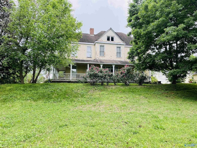 view of front of house with a front lawn and a porch