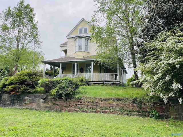 victorian home featuring a front yard and a porch