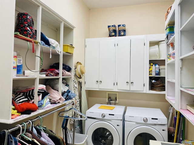 clothes washing area featuring cabinets and washer and dryer