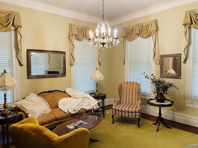 sitting room featuring carpet floors, ornamental molding, and a chandelier