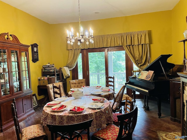 dining area with an inviting chandelier and dark hardwood / wood-style flooring