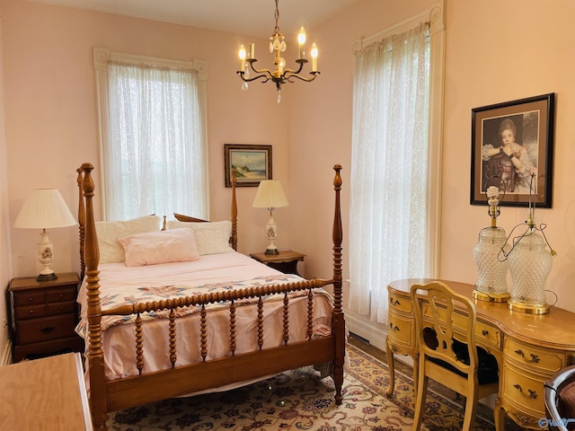 bedroom featuring multiple windows and an inviting chandelier