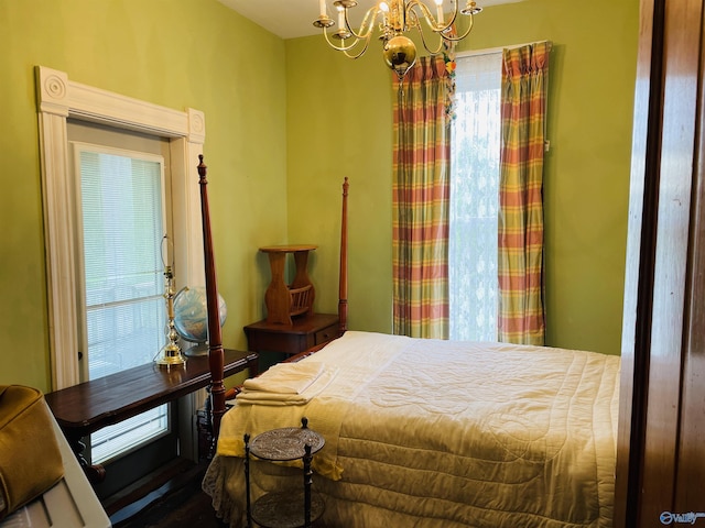 bedroom featuring multiple windows and a notable chandelier