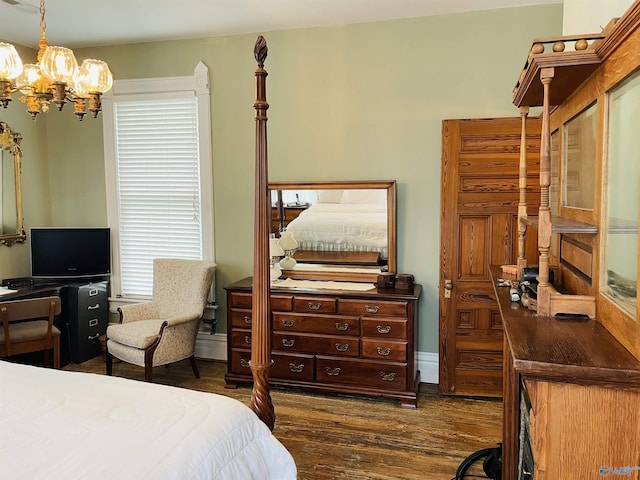bedroom with dark wood-type flooring and an inviting chandelier