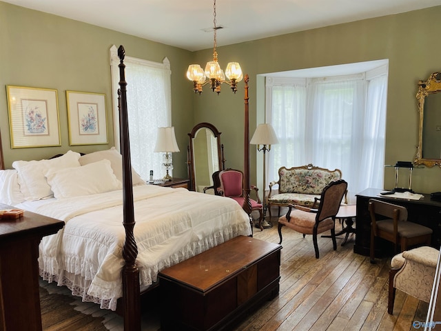 bedroom featuring a notable chandelier and dark wood-type flooring
