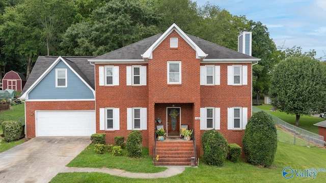 view of front of home with a garage and a front lawn