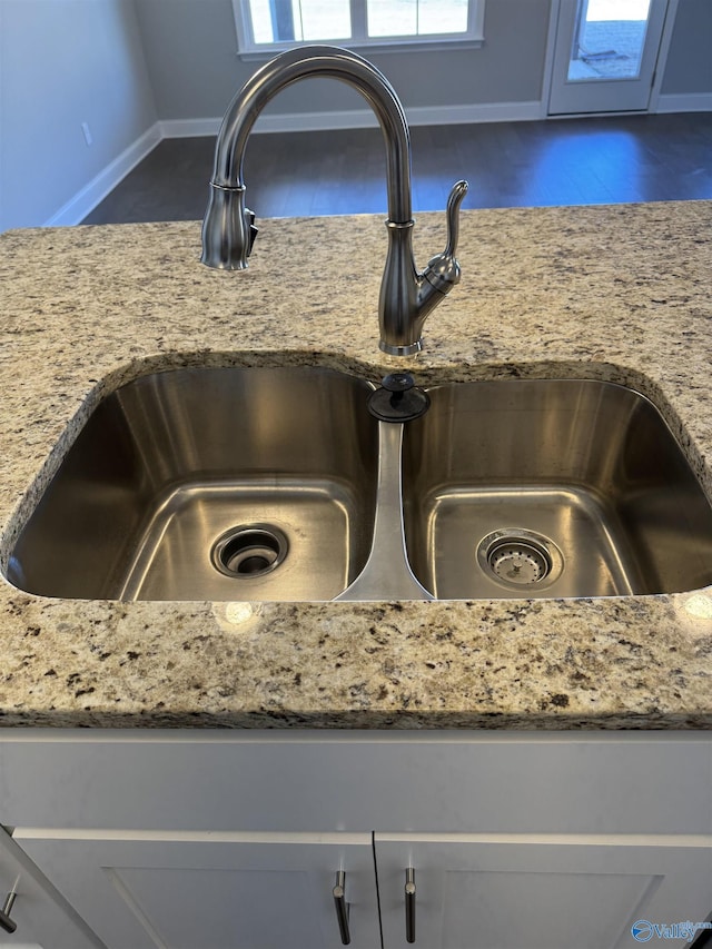 room details featuring sink and light stone countertops