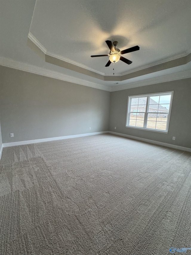 carpeted empty room with crown molding, a textured ceiling, a raised ceiling, and ceiling fan