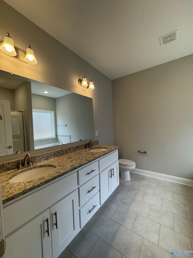 bathroom featuring walk in shower, vanity, and toilet