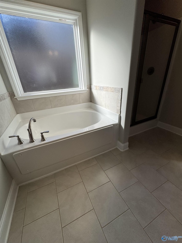 bathroom featuring tile patterned floors and a tub