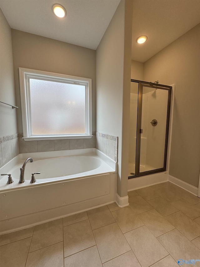 bathroom featuring tile patterned flooring and separate shower and tub