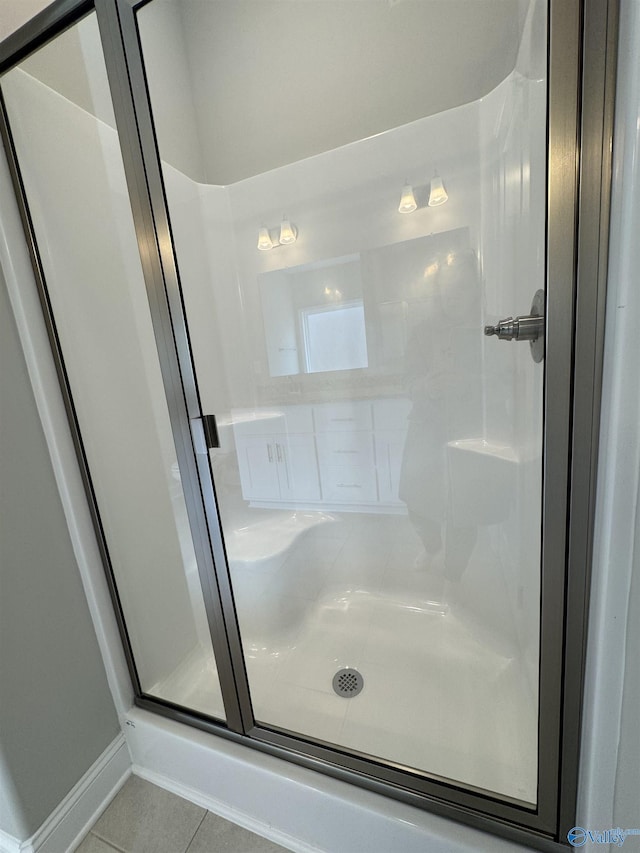 bathroom featuring a shower with door and tile patterned floors