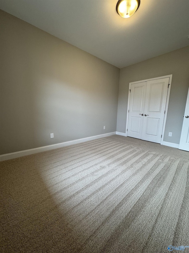 unfurnished bedroom featuring carpet flooring and a closet