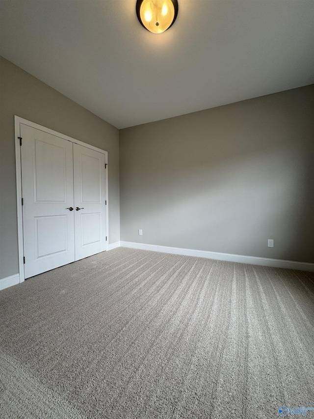 unfurnished bedroom with carpet flooring and a closet