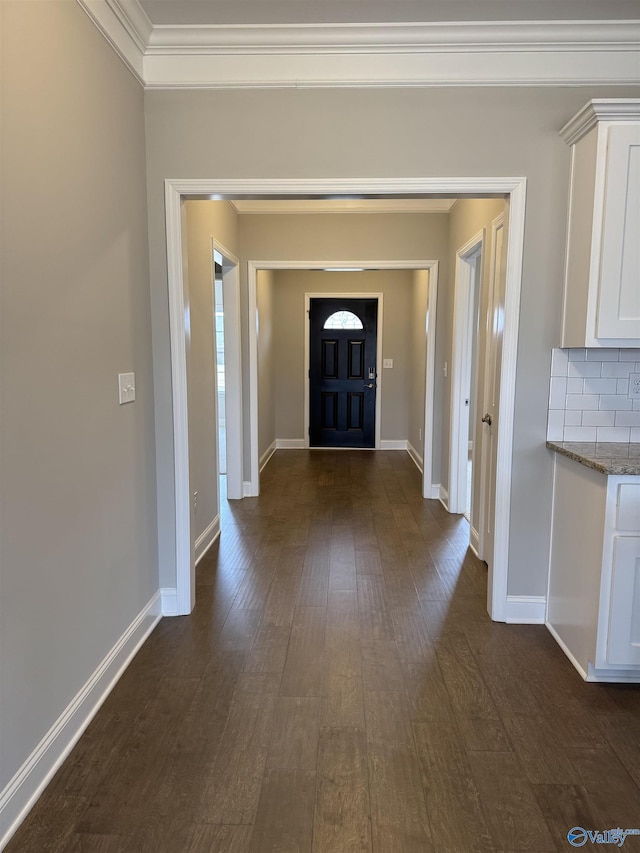 entrance foyer featuring crown molding and dark hardwood / wood-style flooring