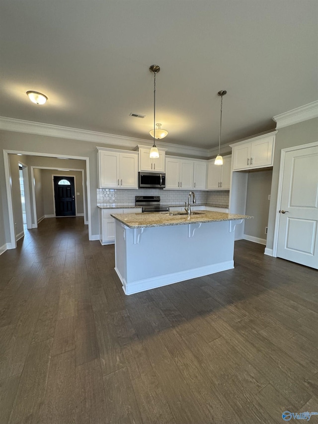 kitchen featuring decorative light fixtures, sink, white cabinets, stainless steel appliances, and light stone countertops