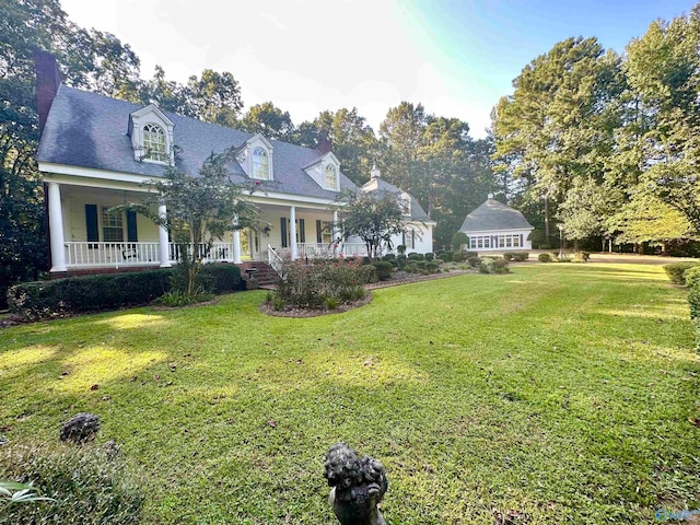 cape cod home featuring a front lawn and covered porch