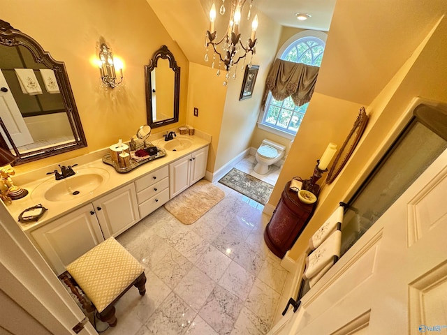 bathroom featuring vanity, toilet, vaulted ceiling, and a notable chandelier