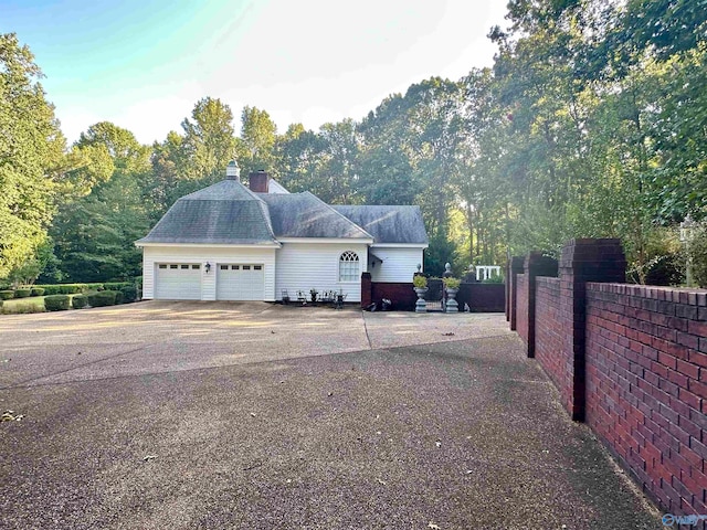 view of side of home with a garage