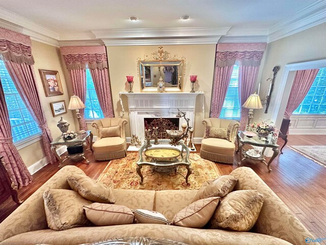 living room featuring hardwood / wood-style flooring, ornamental molding, and a wealth of natural light