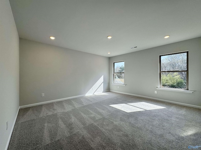 carpeted spare room with visible vents, recessed lighting, and baseboards