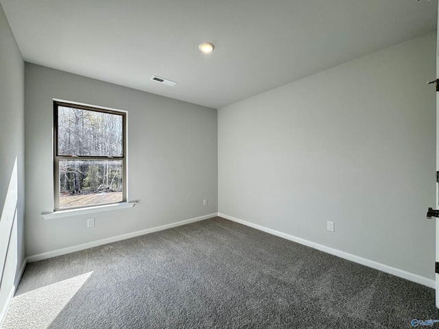 carpeted empty room with visible vents and baseboards