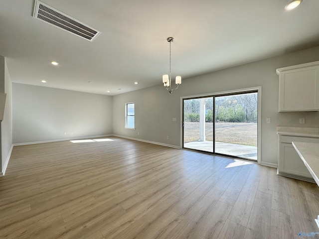 unfurnished room with recessed lighting, visible vents, a healthy amount of sunlight, and light wood-style floors