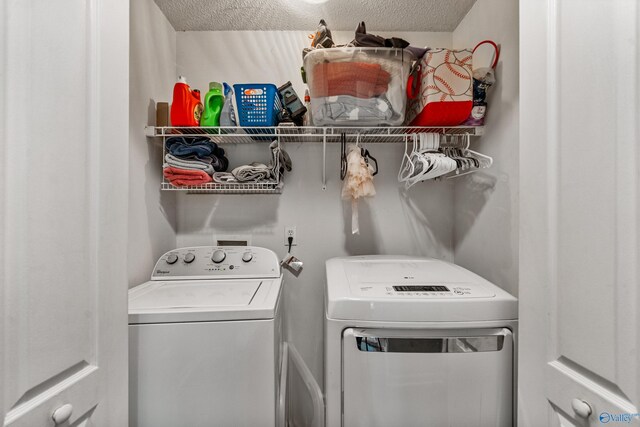 982 Bell Factory Rd, Huntsville, AL 35811 - clothes washing area featuring a textured ceiling, washer and dryer, and laundry area