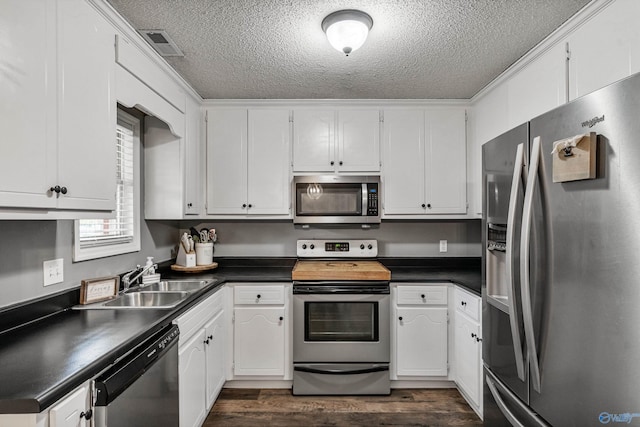 982 Bell Factory Rd, Huntsville, AL 35811 - kitchen featuring a textured ceiling, dark countertops, stainless steel appliances, and a sink