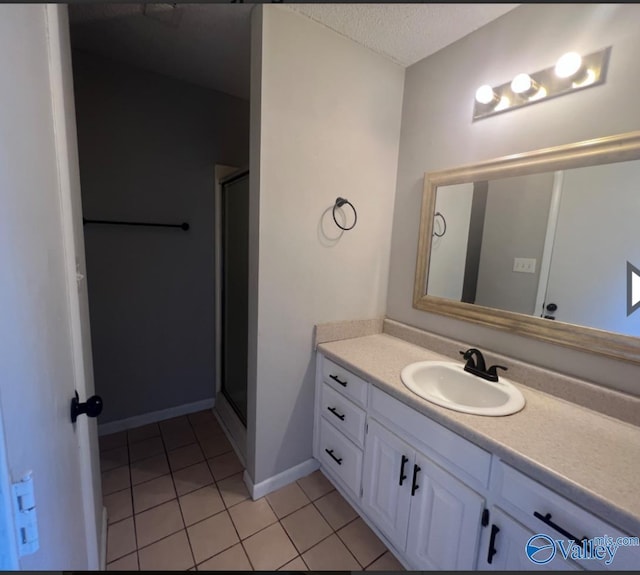 1008 Brighton Cir, Huntsville, AL 35803 - full bathroom featuring vanity, tile patterned flooring, a stall shower, and baseboards