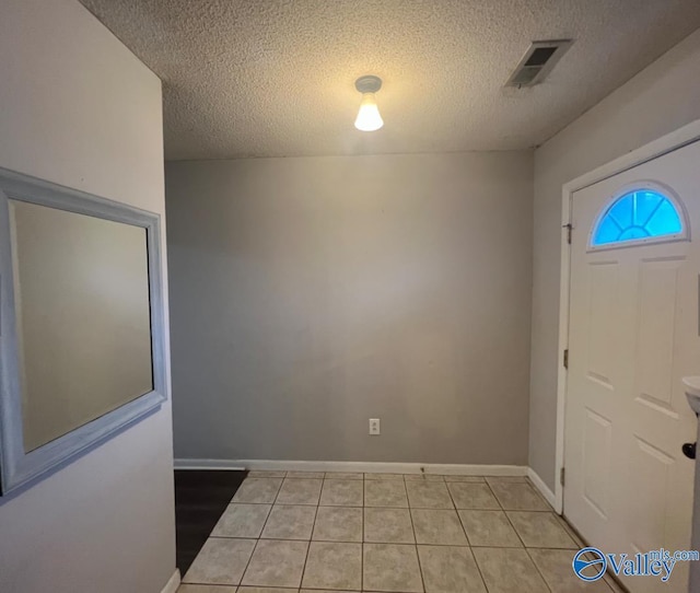 1008 Brighton Cir, Huntsville, AL 35803 - foyer entrance featuring a textured ceiling, light tile patterned flooring, and baseboards