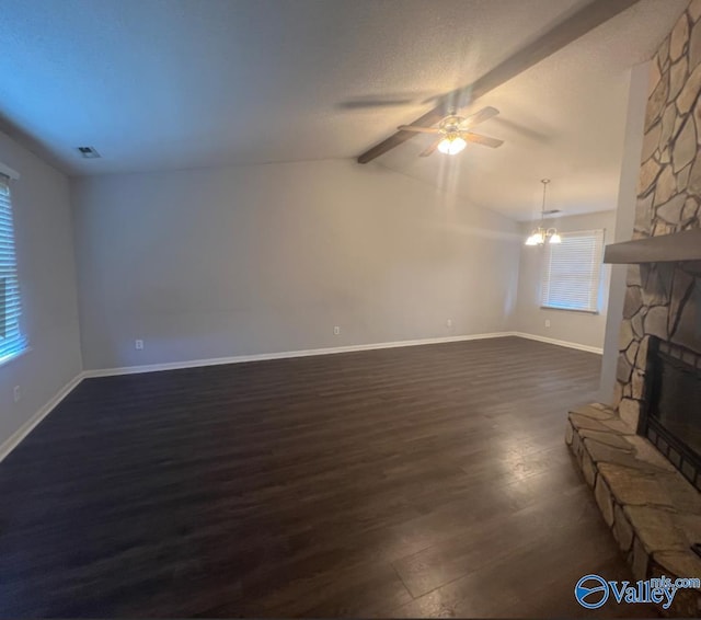 1008 Brighton Cir, Huntsville, AL 35803 - unfurnished living room featuring dark wood finished floors, ceiling fan, baseboards, a stone fireplace, and a chandelier