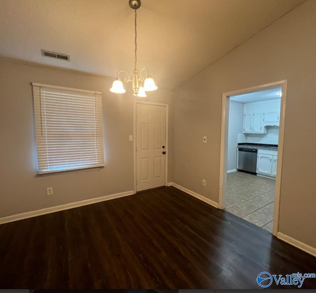 1008 Brighton Cir, Huntsville, AL 35803 - unfurnished dining area with wood finished floors, a chandelier, baseboards, and vaulted ceiling