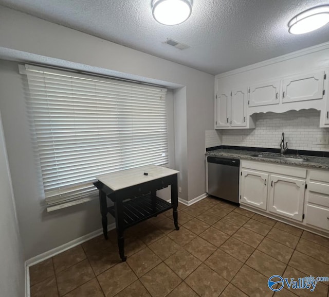 1008 Brighton Cir, Huntsville, AL 35803 - kitchen featuring dishwasher, a sink, dark countertops, white cabinets, and a textured ceiling