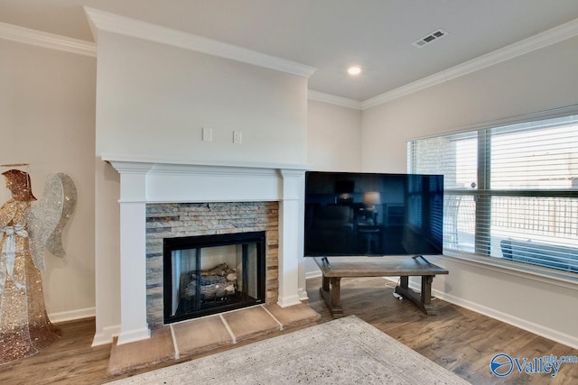 living room featuring hardwood / wood-style flooring, crown molding, and a fireplace