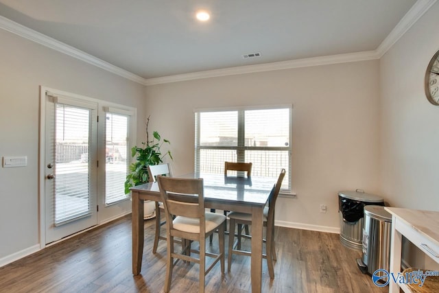 dining room with dark hardwood / wood-style floors and ornamental molding