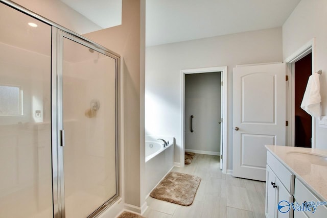 bathroom featuring vanity and plus walk in shower