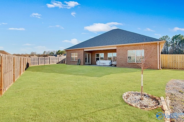 rear view of house with a yard