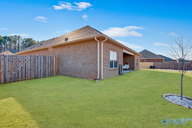 view of side of property with a lawn