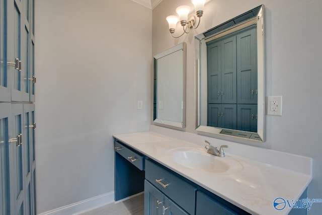 bathroom with vanity, crown molding, and baseboards