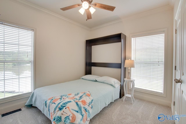 bedroom featuring visible vents, ornamental molding, carpet floors, and multiple windows