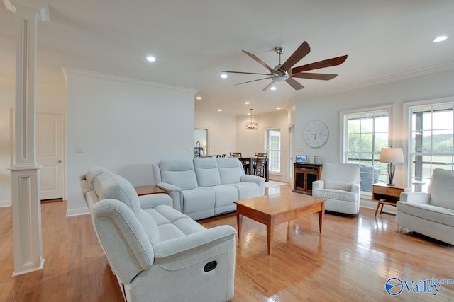 living area featuring recessed lighting, decorative columns, ornamental molding, light wood-type flooring, and a ceiling fan