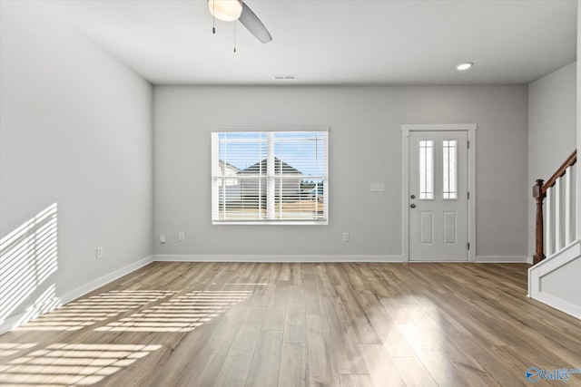 entrance foyer with light wood-type flooring, a wealth of natural light, and ceiling fan