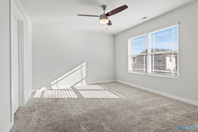 carpeted spare room featuring ceiling fan