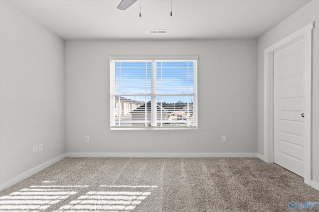 spare room featuring carpet flooring and ceiling fan