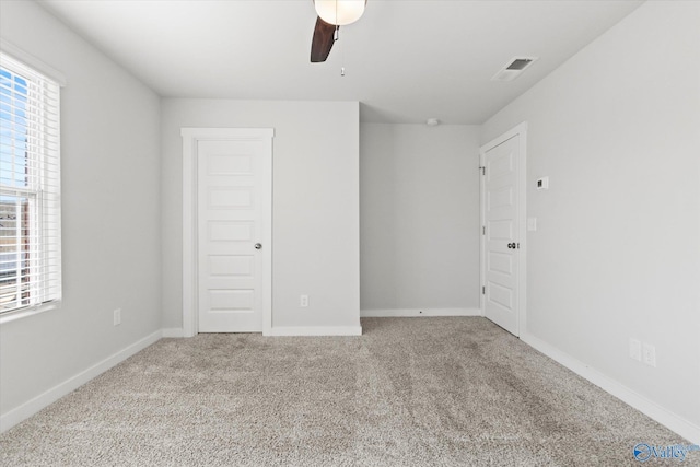 unfurnished room featuring ceiling fan and light carpet