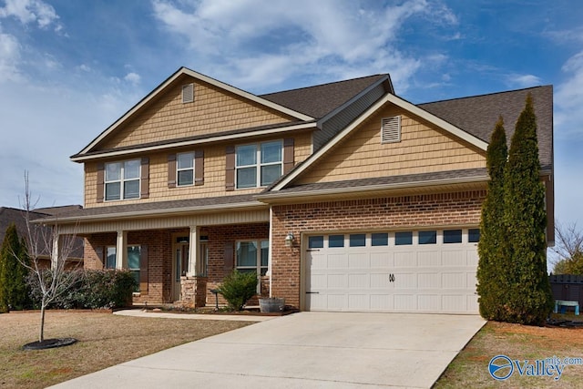 craftsman-style house with a garage, concrete driveway, brick siding, and covered porch