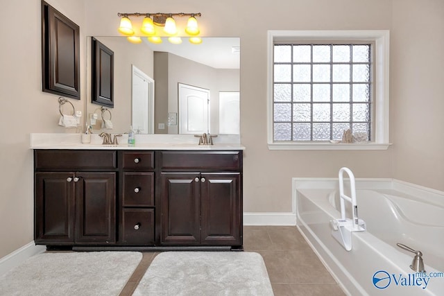 bathroom with tile patterned flooring, a sink, baseboards, a bath, and double vanity