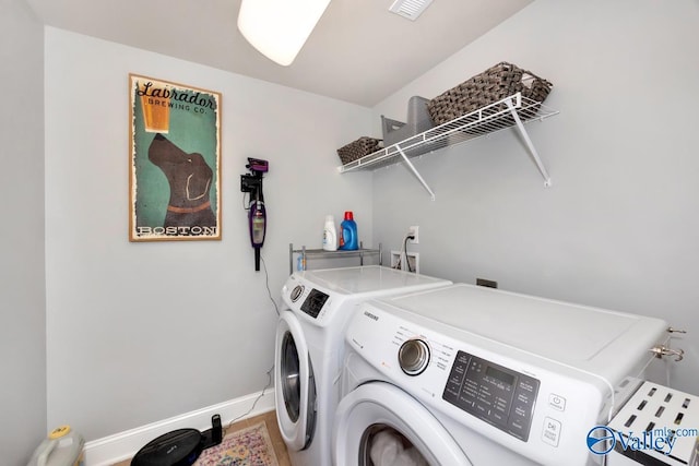 laundry room featuring laundry area, washer and clothes dryer, visible vents, and baseboards