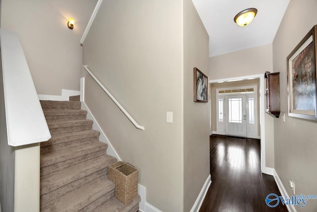 stairs featuring baseboards and hardwood / wood-style flooring